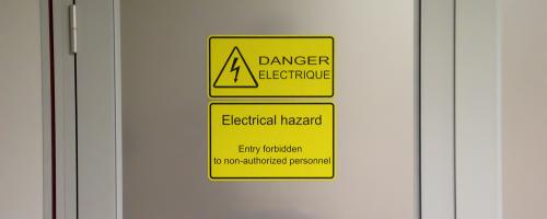 Laser engraved safety signage made of Gravoply™ Laser on an industrial door for workplace safety 